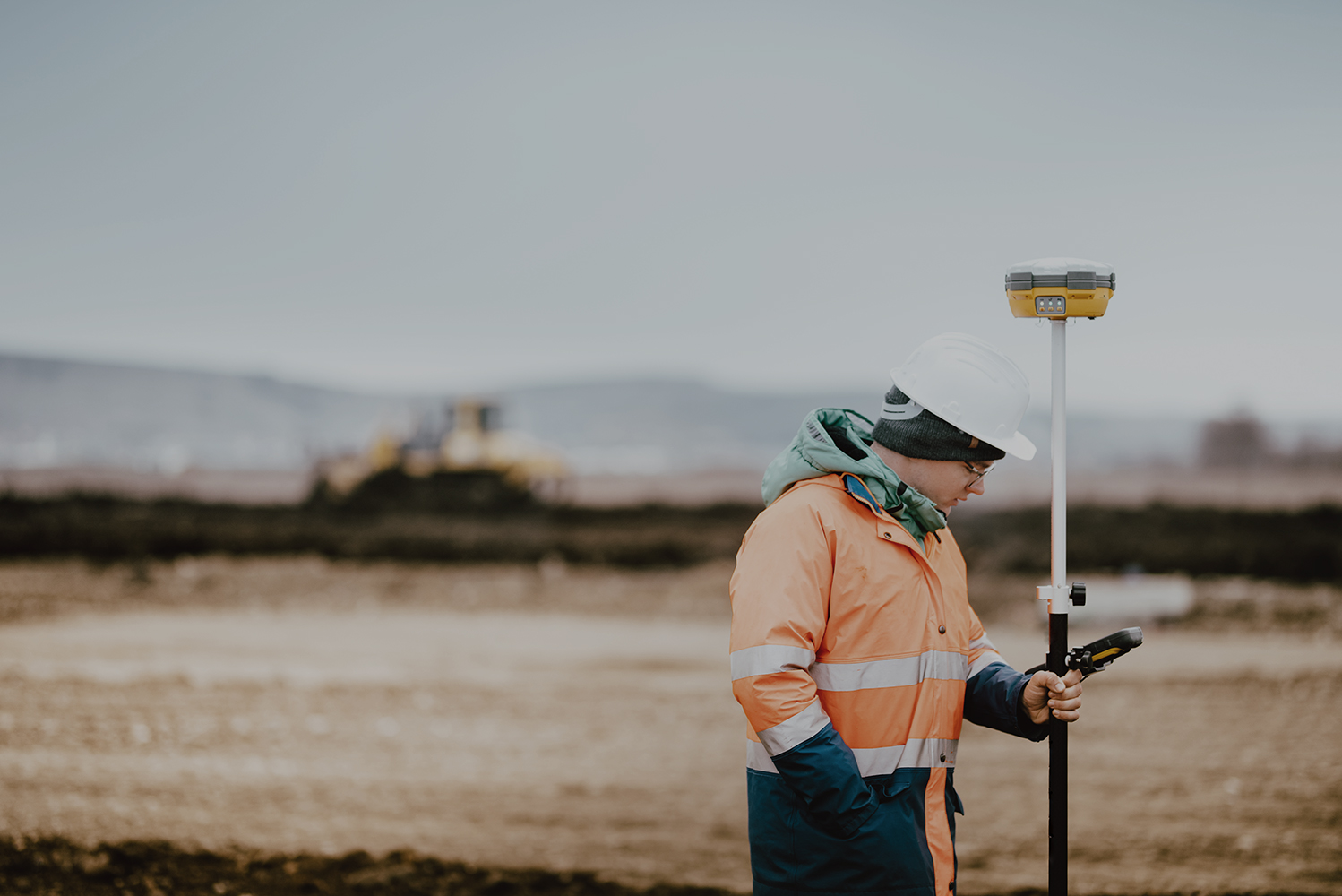 Surveyor engineer working with technology for coordinating heavy